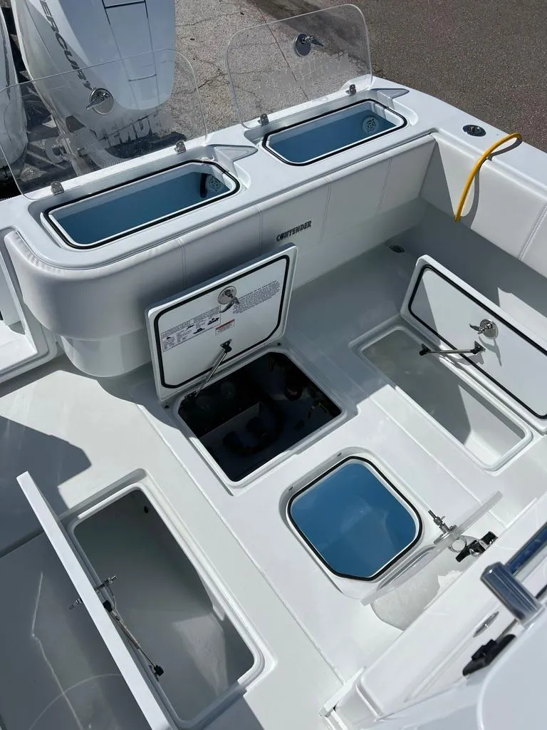 Slide: The Image of 2025 Contender 32 ST boat deck with storage compartments and live wells. - 9