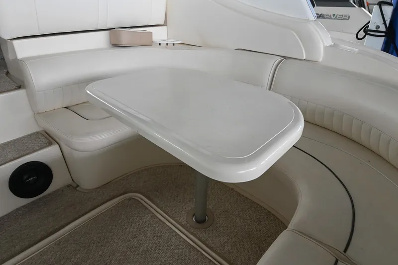 Slide: The Image of 2005 Cruisers Yachts 370 Express interior with white seating and table. - 11