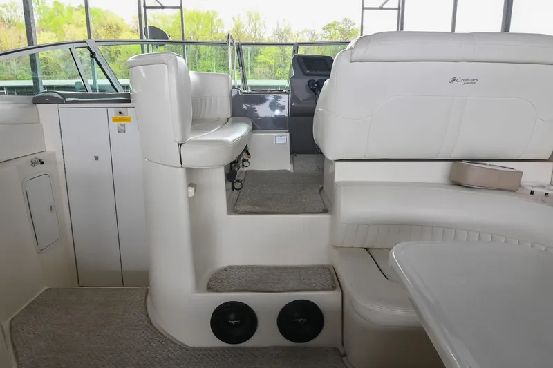 Slide: The Image of 2005 Cruisers Yachts 370 Express interior with white seating and helm, showcasing luxury design. - 14