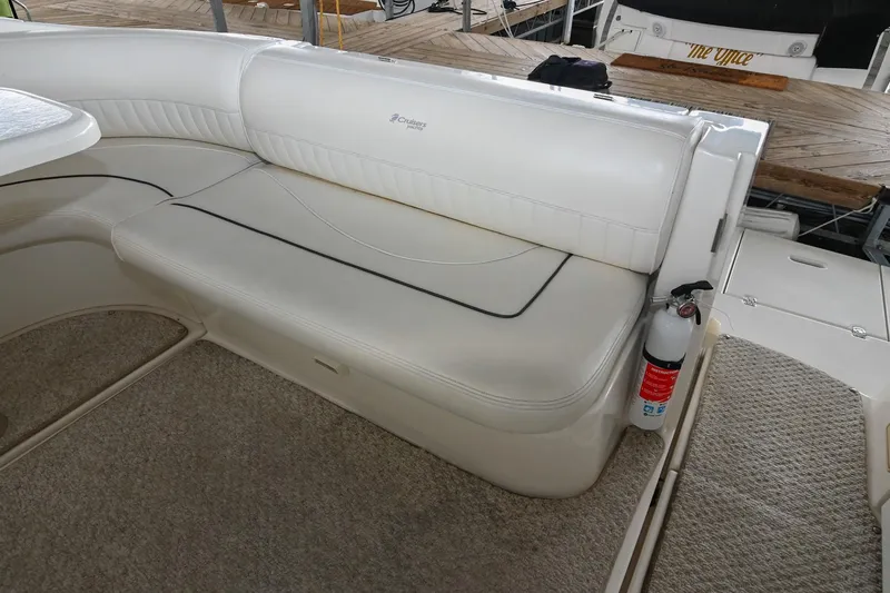 Slide: The Image of 2005 Cruisers Yachts 370 Express interior with white seating and fire extinguisher. - 7
