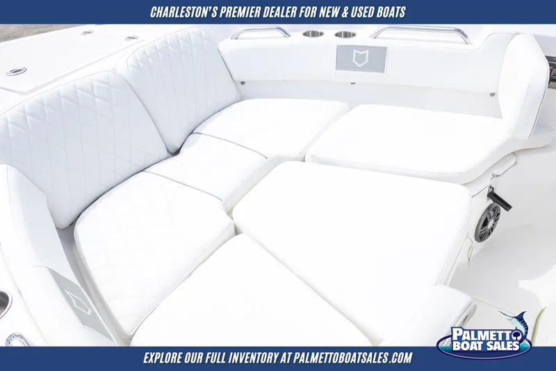 Slide: The Image of 2025 Sea Fox 228 Commander boat with white cushioned seating, showcased by Palmetto Boat Sales. - 19
