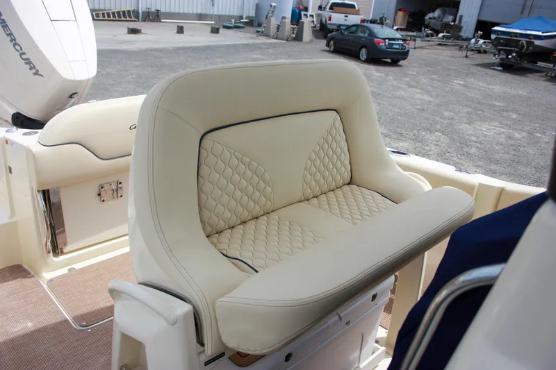 Slide: The Image of 2024 Chris-Craft Catalina 24 boat seat with quilted upholstery in a marina setting. - 12