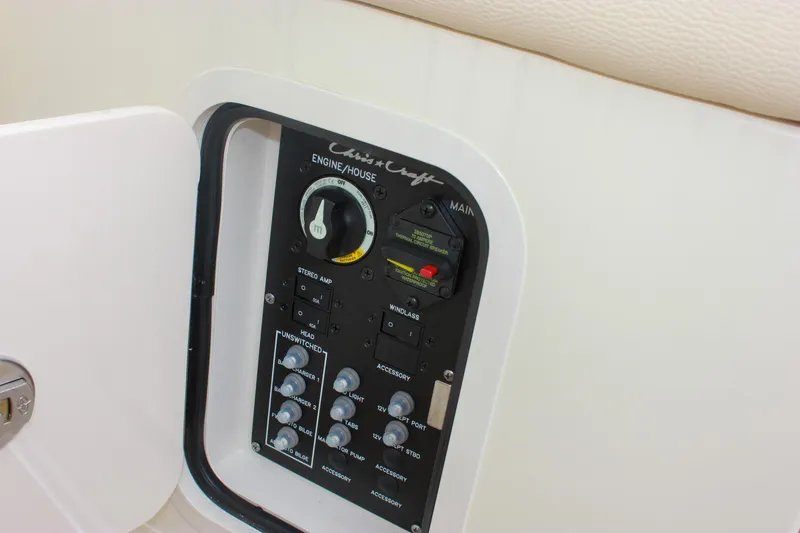 Slide: The Image of 2024 Chris-Craft Catalina 24 control panel with switches and gauges. - 14