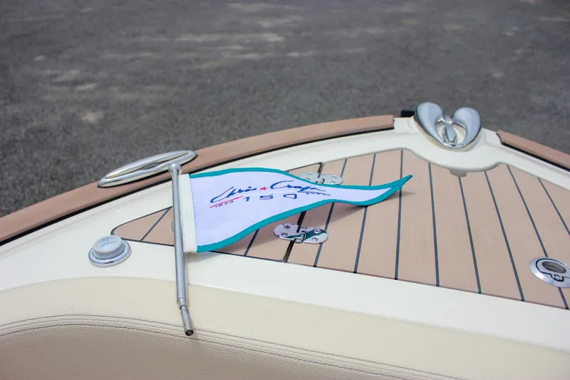 Slide: The Image of 2024 Chris-Craft Catalina 24 boat deck with branded flag and sleek design. - 16