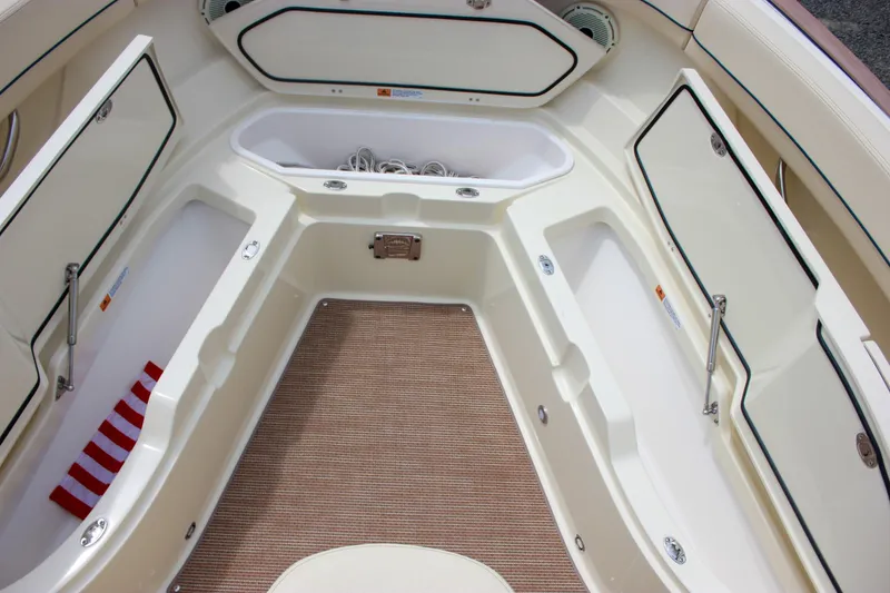 Slide: The Image of 2024 Chris-Craft Catalina 24 boat interior with storage compartments and beige flooring. - 17