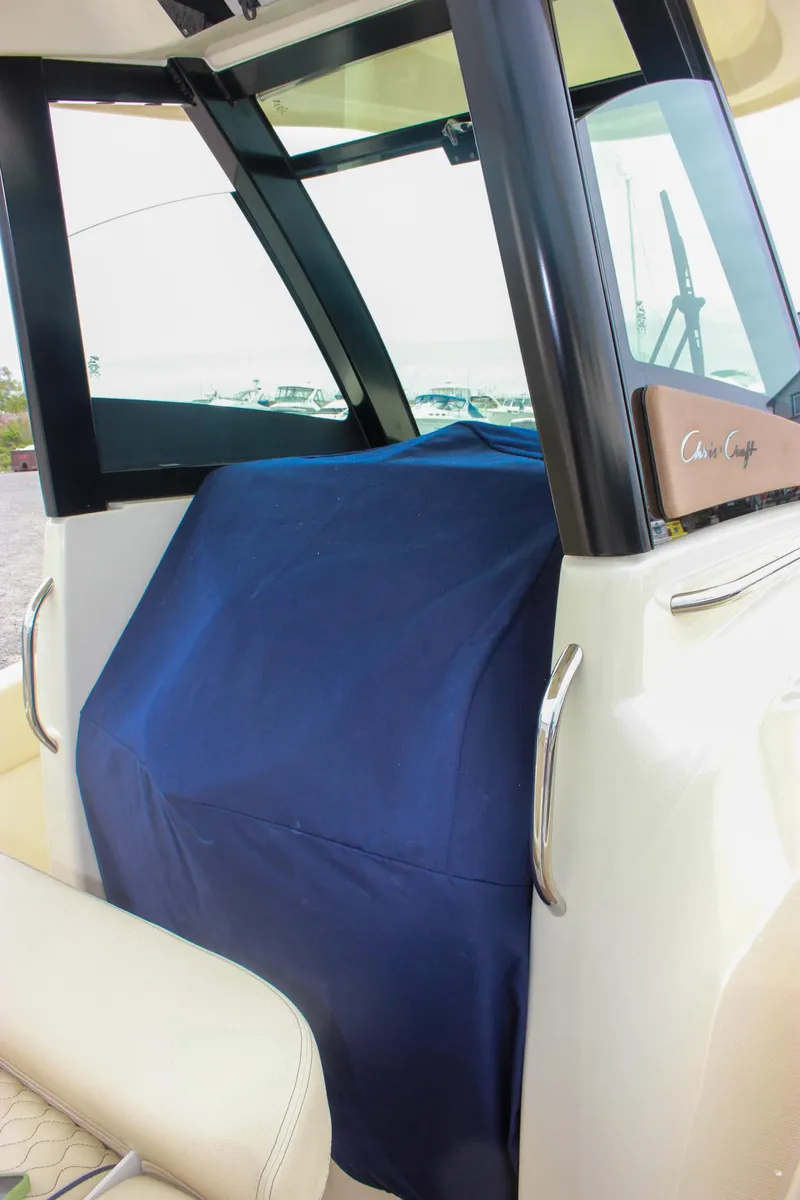 Slide: The Image of 2024 Chris-Craft Catalina 24 boat interior with covered console and seating. - 24