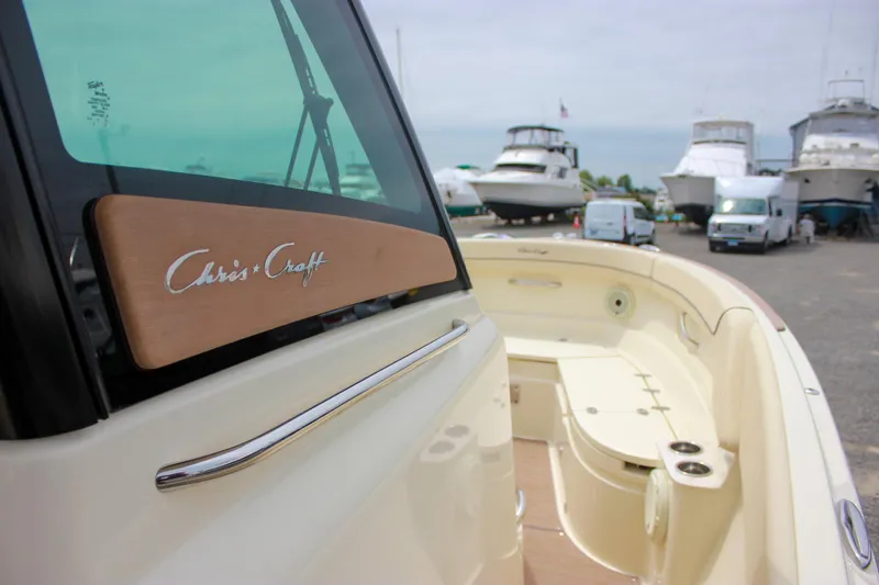 Slide: The Image of 2024 Chris-Craft Catalina 24 boat docked, showcasing sleek design and spacious deck. - 25