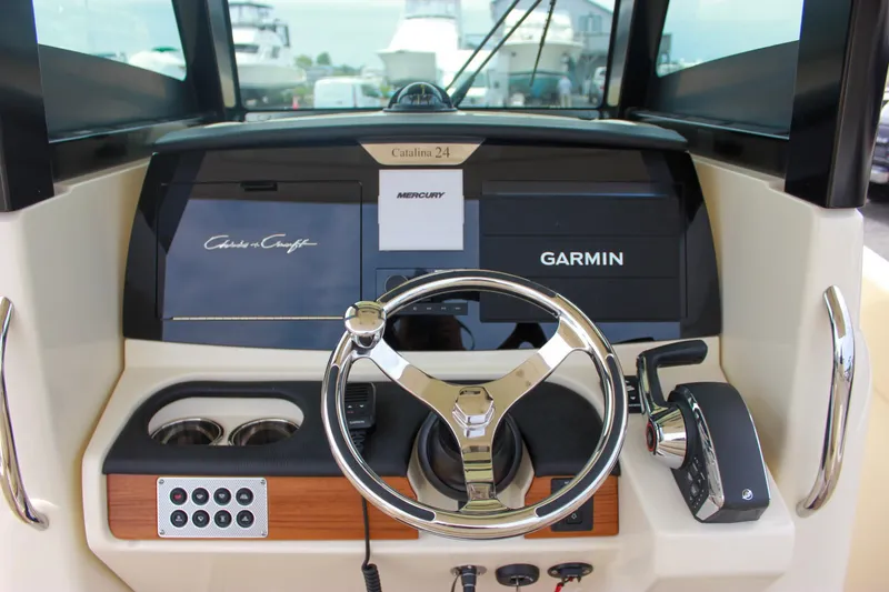 Slide: The Image of 2024 Chris-Craft Catalina 24 helm with Garmin navigation and Mercury controls. - 28