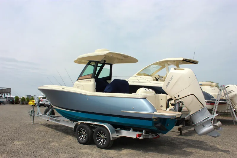 Slide: The Image of 2024 Chris-Craft Catalina 24 boat on trailer, parked outdoors, side view. - 3