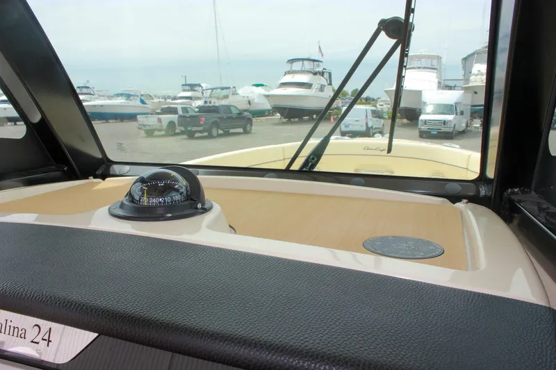 Slide: The Image of 2024 Chris-Craft Catalina 24 dashboard view with compass, marina background. - 30