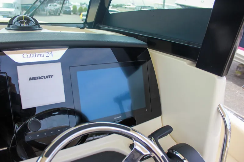 Slide: The Image of 2024 Chris-Craft Catalina 24 dashboard with Mercury display and steering wheel. - 31