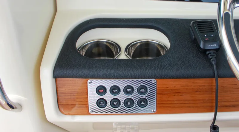 Slide: The Image of 2024 Chris-Craft Catalina 24 dashboard with cup holders and control panel. - 32