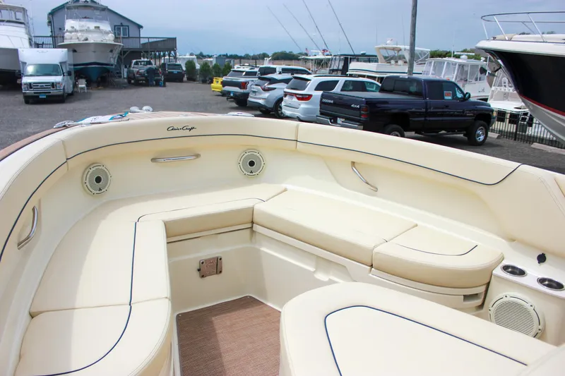 Slide: The Image of 2024 Chris-Craft Catalina 24 boat interior with beige seating, parked in a marina. - 35