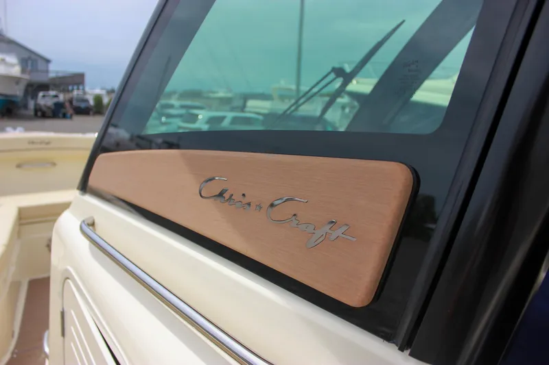 Slide: The Image of 2024 Chris-Craft Catalina 24 boat with logo on window, docked at marina. - 37