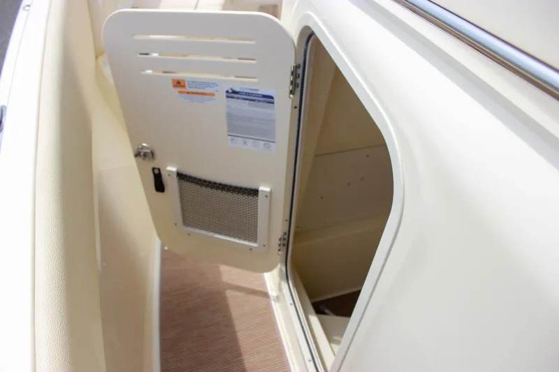 Slide: The Image of 2024 Chris-Craft Catalina 24 storage compartment with open door, showcasing interior space. - 38