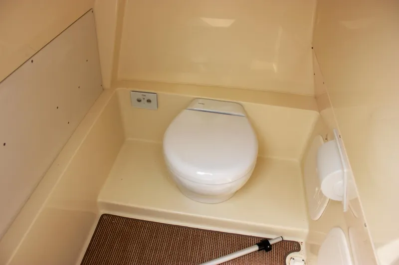 Slide: The Image of 2024 Chris-Craft Catalina 24 boat interior with compact marine toilet. - 39