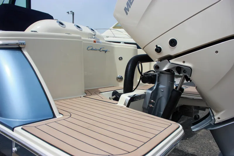 Slide: The Image of 2024 Chris-Craft Catalina 24 boat with outboard motor and teak deck. - 4