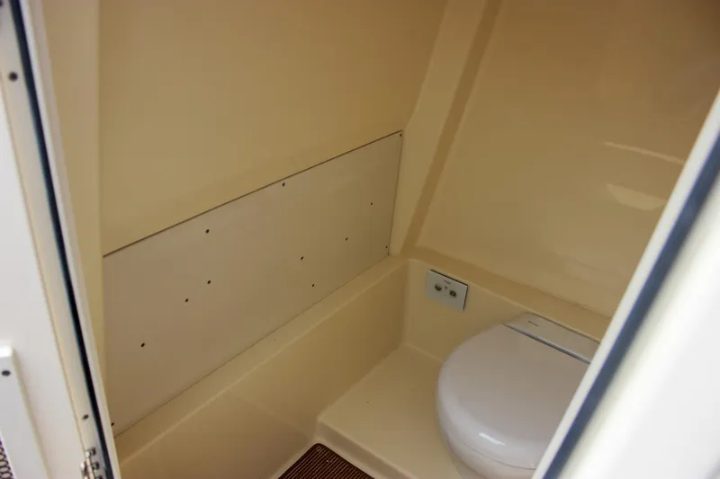 Slide: The Image of 2024 Chris-Craft Catalina 24 boat interior with compact marine toilet. - 40