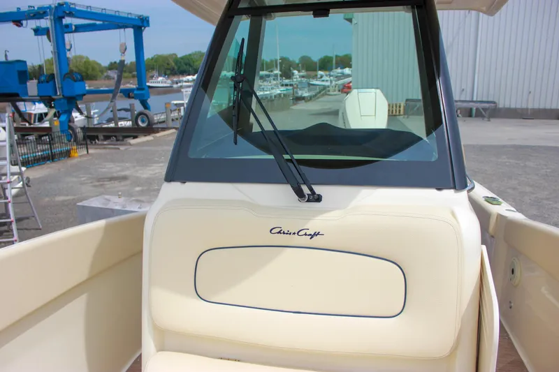 Slide: The Image of 2024 Chris-Craft Catalina 24 boat, docked with visible windshield and seating area. - 42