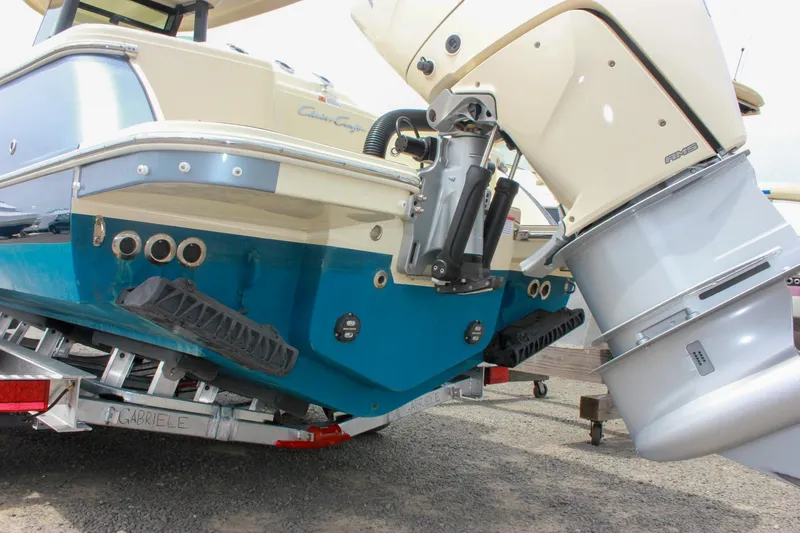Slide: The Image of 2024 Chris-Craft Catalina 24 boat on trailer, showcasing rear view and outboard motor. - 43