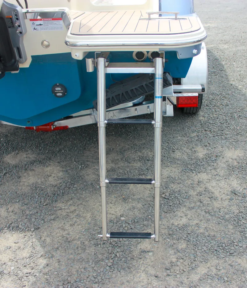 Slide: The Image of 2024 Chris-Craft Catalina 24 swim platform with retractable ladder on gravel surface. - 44