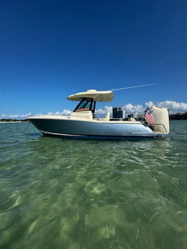 Slide: The Image of 2024 Chris-Craft Catalina 24 boat on clear water under blue sky. - 51