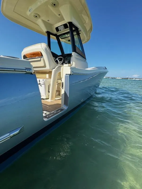 Slide: The Image of 2024 Chris-Craft Catalina 24 boat on clear water under a bright blue sky. - 52