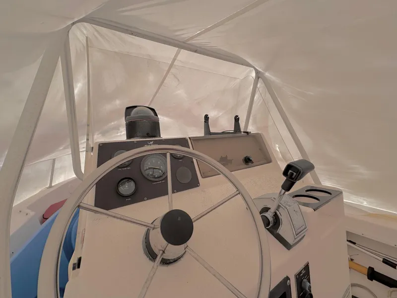 Slide: The Image of 1997 Mako 191 boat cockpit with steering wheel and control panel. - 5