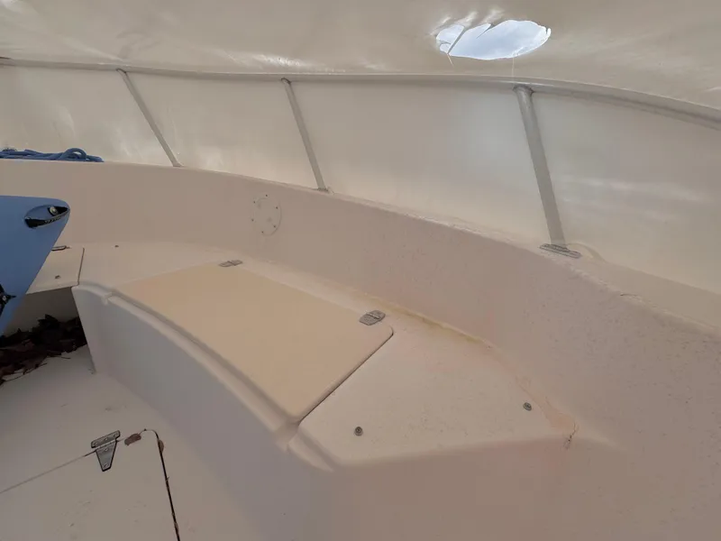 Slide: The Image of Interior view of a 1997 Mako 191 boat, featuring seating and storage compartments. - 8
