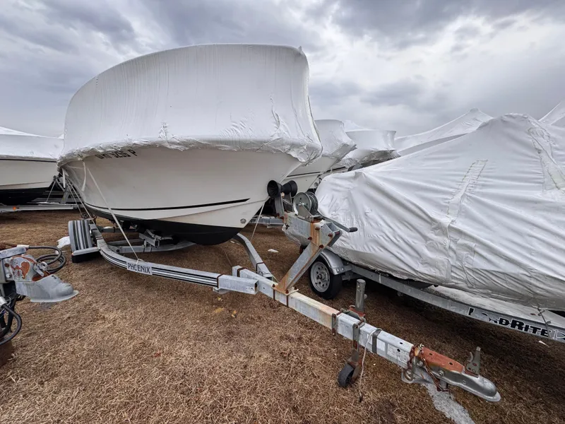 Slide: The Image of Covered 1997 Mako 191 boat on trailer under cloudy sky. - 9