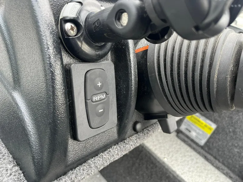 Slide: The Image of Control panel of 2023 Lund 1650 Rebel XL SS boat, featuring RPM adjustment buttons. - 13