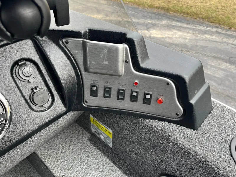 Slide: The Image of Control panel of 2023 Lund 1650 Rebel XL SS boat with switches and outlets. - 14