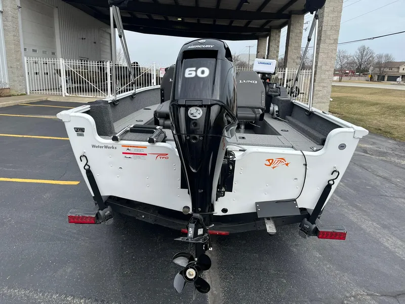 Slide: The Image of 2023 Lund 1650 Rebel XL SS boat with a 50 HP Mercury outboard motor. - 2