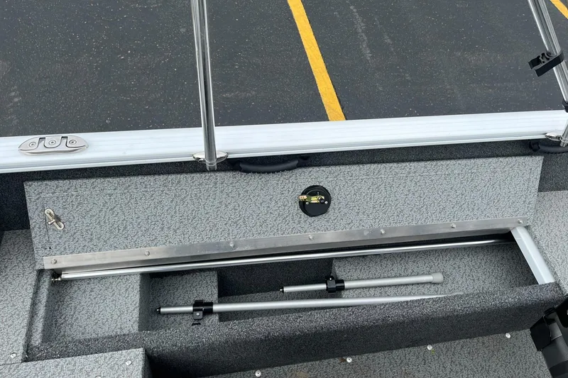 Slide: The Image of 2023 Lund 1650 Rebel XL SS boat interior with storage compartment and rod holder. - 20