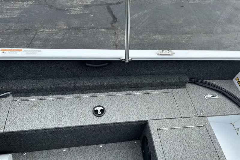 Slide: The Image of 2023 Lund 1650 Rebel XL SS boat interior with gray textured flooring. - 21