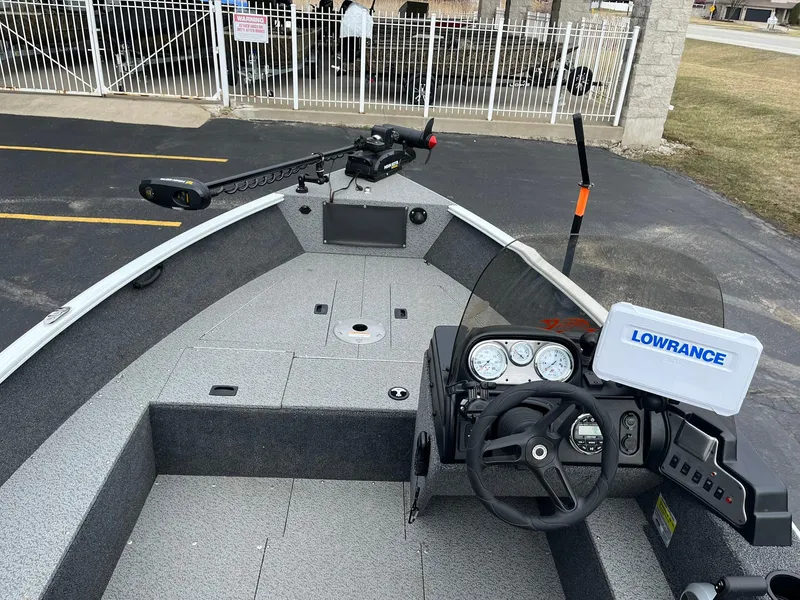Slide: The Image of 2023 Lund 1650 Rebel XL SS boat interior with steering wheel and Lowrance navigation system. - 5