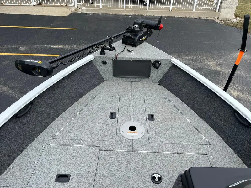 Slide: The Image of 2023 Lund 1650 Rebel XL SS boat deck with trolling motor and storage compartments. - 6