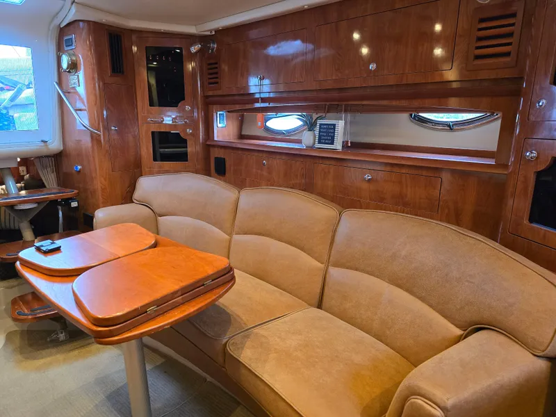 Slide: The Image of Luxurious interior of 2007 Four Winns 358 Vista yacht with plush seating and wooden cabinetry. - 11