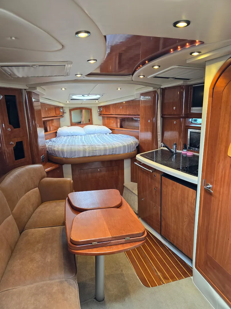 Slide: The Image of Luxurious 2007 Four Winns 358 Vista cabin interior with kitchen, seating, and bed. - 12