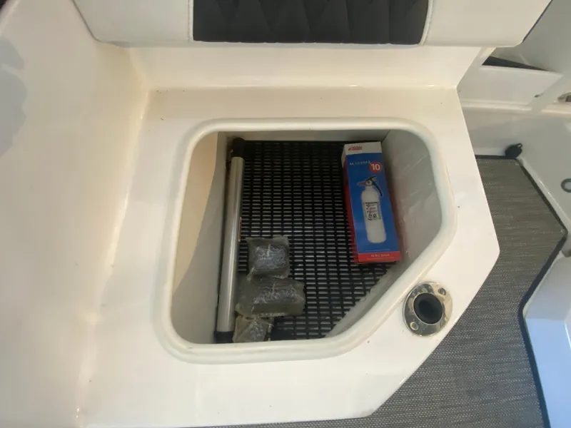 Slide: The Image of Storage compartment in a 2023 Monterey 298 SUPER SPORT BR boat with items inside. - 18
