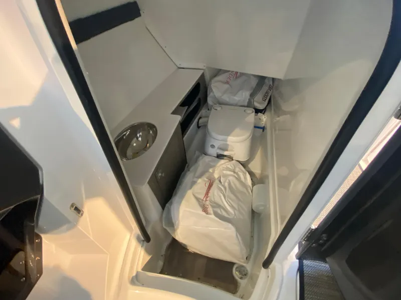 Slide: The Image of 2023 Monterey 298 SUPER SPORT BR boat interior with compact bathroom amenities. - 27