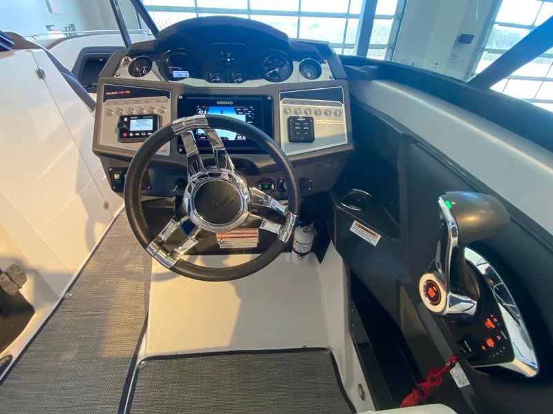 Slide: The Image of 2023 Monterey 298 SUPER SPORT BR boat dashboard with steering wheel and control panel. - 30