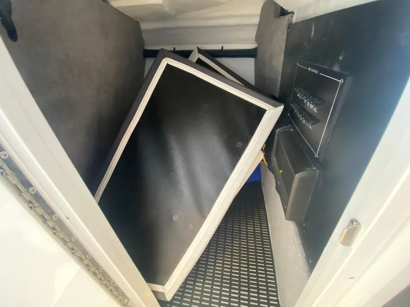Slide: The Image of Storage compartment in a 2023 Monterey 298 SUPER SPORT BR boat, featuring black panels. - 39