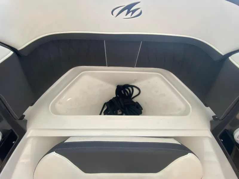 Slide: The Image of 2023 Monterey 298 SUPER SPORT BR boat interior with storage compartment and coiled rope. - 44