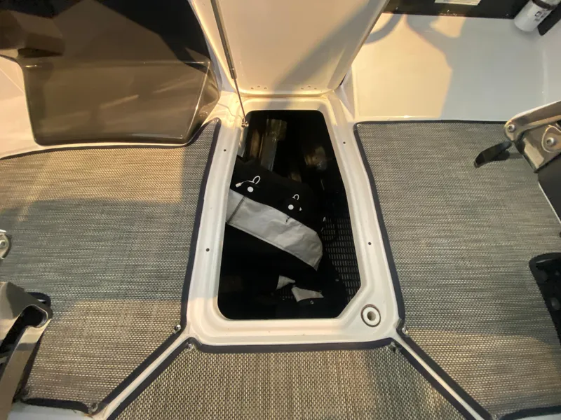 Slide: The Image of 2023 Monterey 298 SUPER SPORT BR boat interior storage compartment with open hatch. - 48