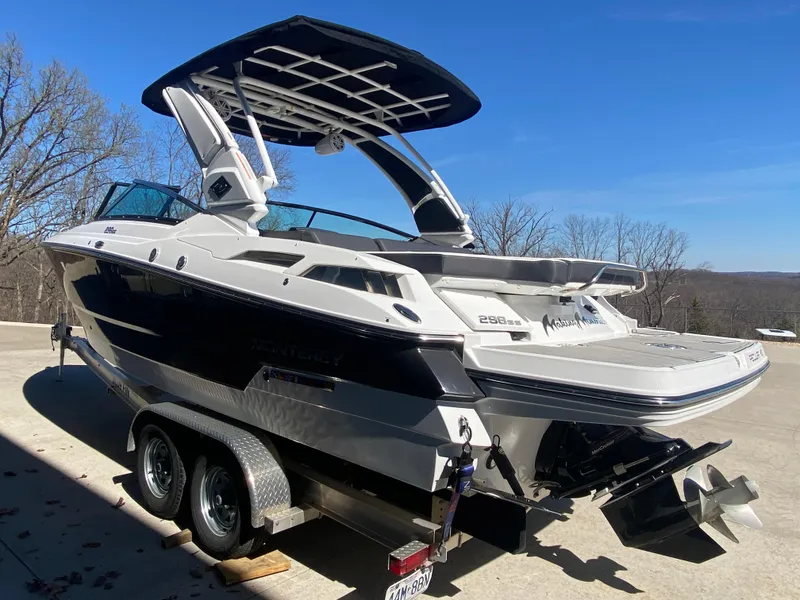 Slide: The Image of 2023 Monterey 298 Super Sport BR boat on trailer, sleek design, outdoor setting. - 5