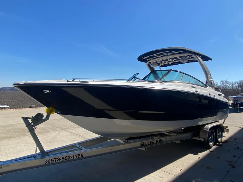 Slide: The Image of 2023 Monterey 298 SUPER SPORT BR boat on trailer under clear blue sky. - 6
