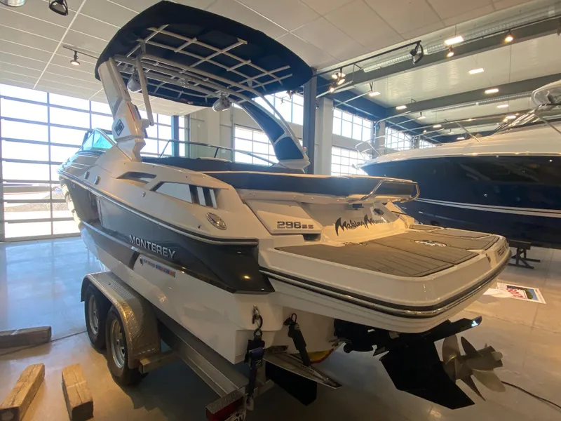 Slide: The Image of 2023 Monterey 298 Super Sport BR boat displayed in a showroom. - 9