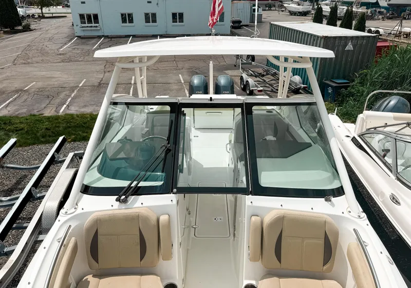 Slide: The Image of 2020 Pursuit DC 266 Dual Console boat with seating, docked in a marina. - 17