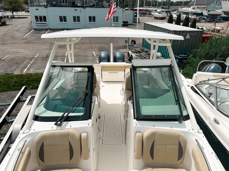 Slide: The Image of 2020 Pursuit DC 266 Dual Console boat with seating, docked at marina. - 18
